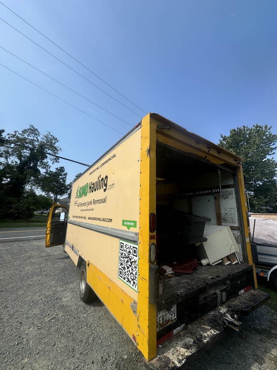 SOMD Hauling box truck loaded with furniture and appliances for a full clean-out