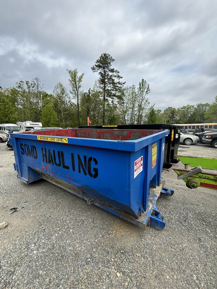 SOMD Hauling blue roll-off dumpster staged in the equipment yard