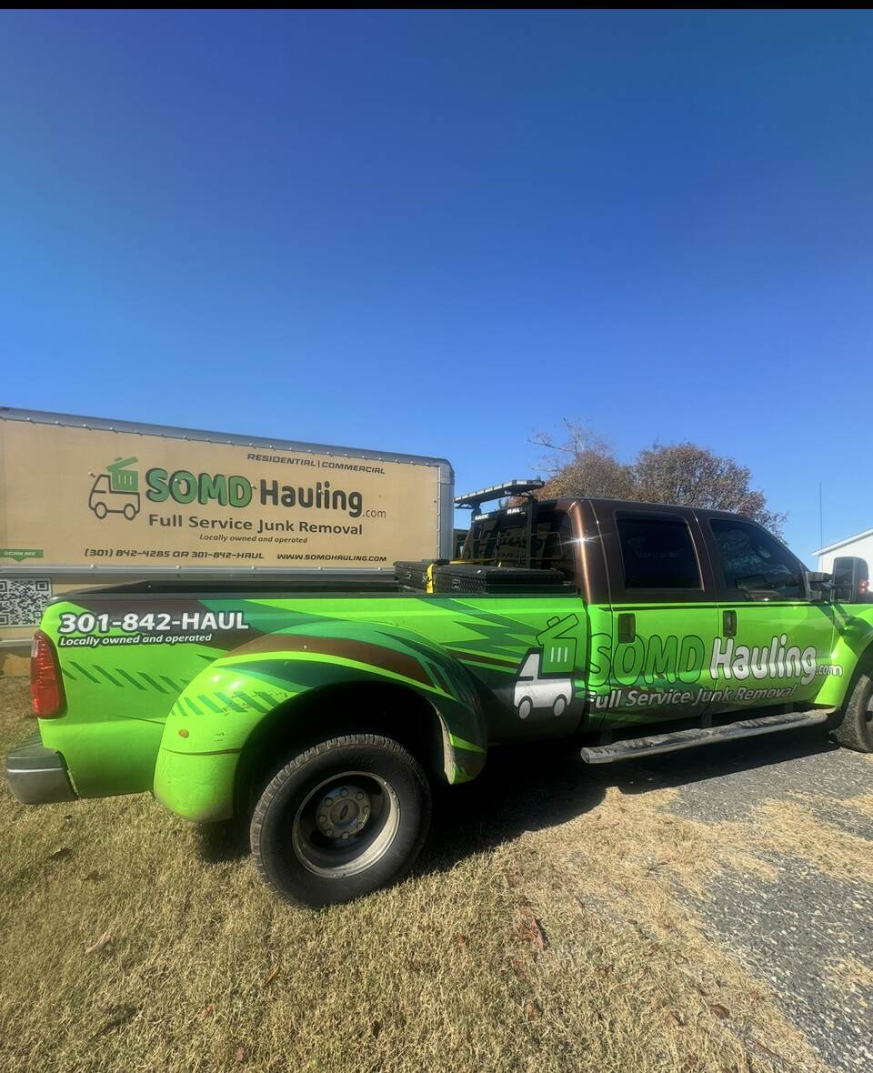 SOMD Hauling branded green pickup truck with full service junk removal wrap